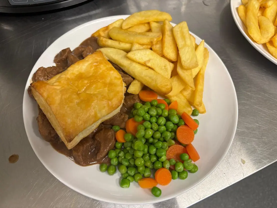 Steak pie with chips and gravy