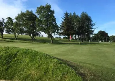Smiling guests enjoying a meal with golf course views